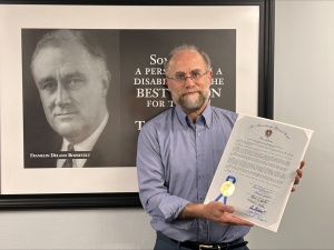 Rick Glassman holds Joi nt Resolution at his farewell lunch